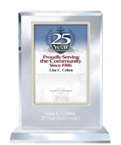 Lisa C. Cohen with an award for 25 years service in the legal community.